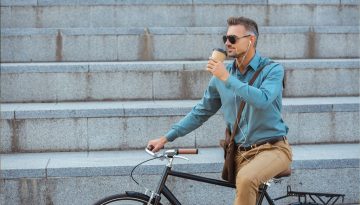 Man on bicycle having a drink