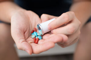 Woman with medication in her hands.